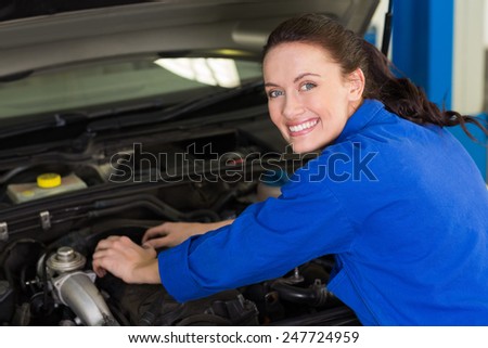 Mechanic working under the hood at the repair garage