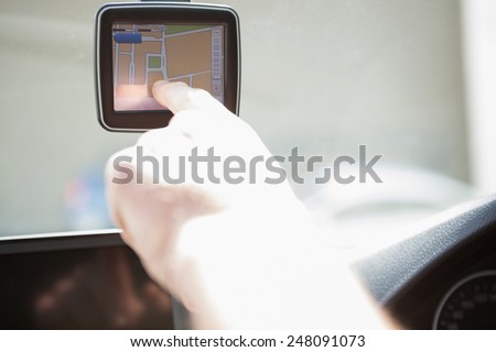 Man using satellite navigation system in his car