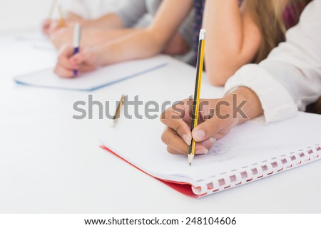 Students taking notes in class at the college