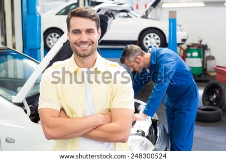 Customer smiling at the camera at the repair garage
