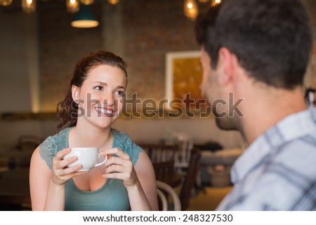 Young couple having coffee together at the cafe