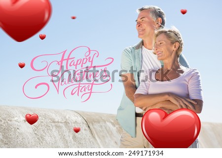 Happy senior couple embracing on the pier against happy valentines day