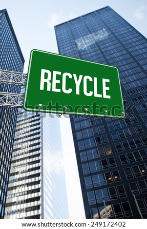 The word recycle and green billboard sign against low angle view of skyscrapers