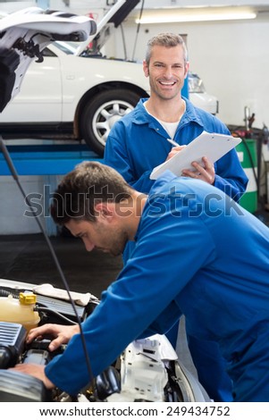 Team of mechanics working together at the repair garage