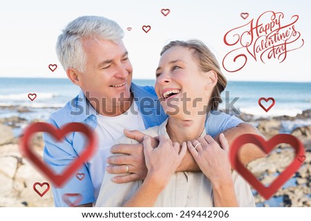 Happy casual couple by the coast against happy valentines day