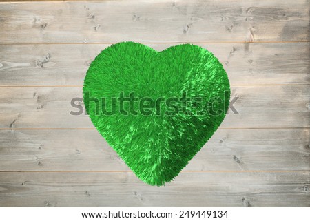 Green heart against bleached wooden planks background
