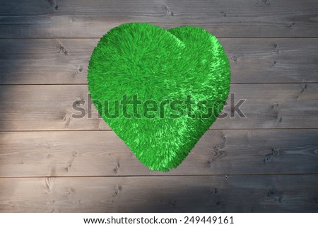 Green heart against bleached wooden planks background