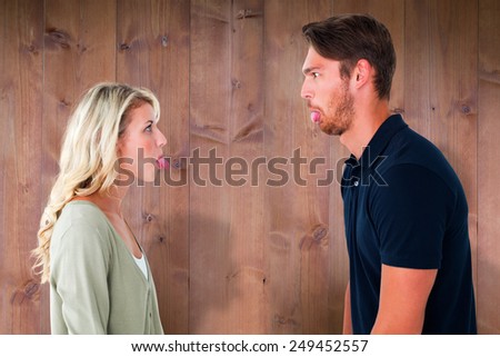 Childish couple having an argument against wooden planks