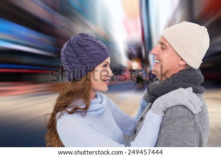 Happy couple in warm clothing against blurry new york street