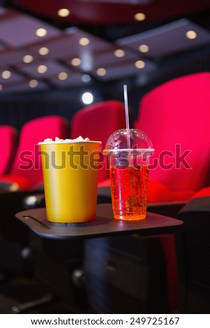 Empty rows of red seats with pop corn and drink on the floor at the cinema
