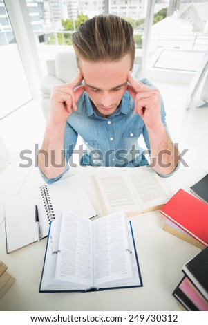 Focused businessman studying at his desk in his office