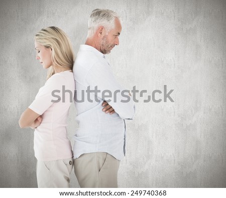 Unhappy couple not speaking to each other against weathered surface