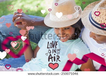 Smiling couple relaxing in their garden against love is in the air