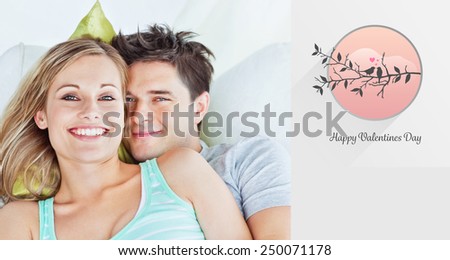 Portrait of an attractive couple hugging and relaxing on the sofa against love birds