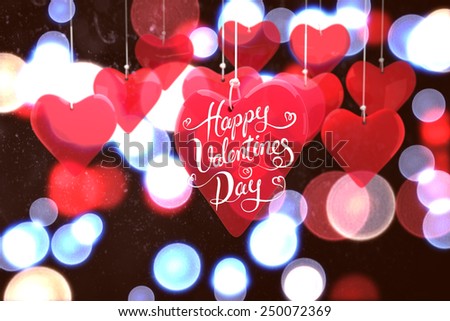 Happy valentines day against twinkling red and blue lights