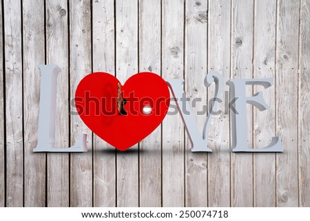 Love with lock and key against digitally generated grey wooden planks