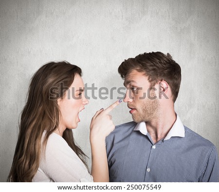 Casual young couple in an argument against weathered surface