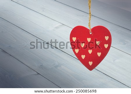 Cute heart decoration against bleached wooden planks background