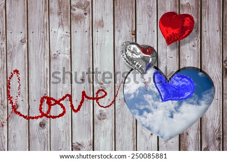 Love spelled out in petals against bright blue sky with clouds