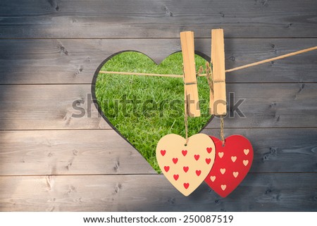 Hearts hanging on the line against heart in wood