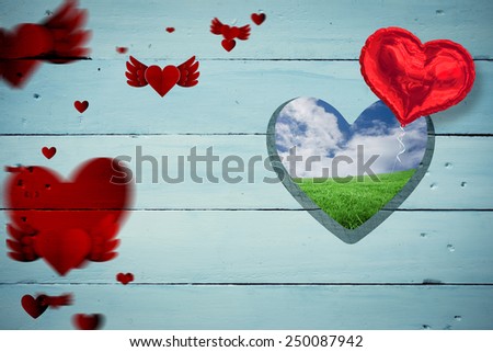 Love heart pattern against green field under blue sky