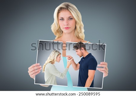 Angry couple facing off during argument against grey vignette