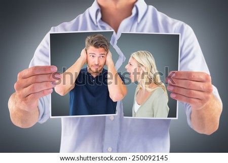 Man not listening to his shouting girlfriend against grey vignette