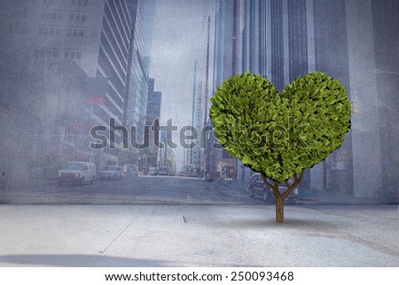 Heart shaped plant against urban projection on wall