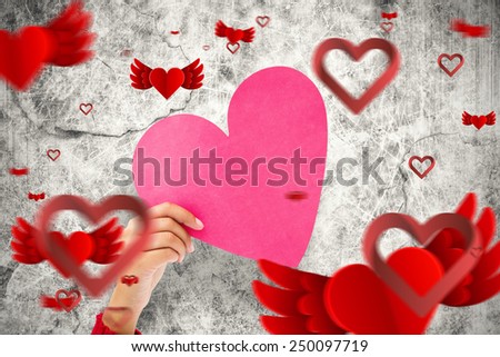 Couple holding a heart against ~love heart pattern