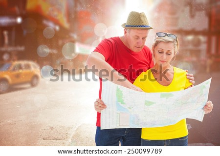 Lost tourist couple using map against blurry new york street