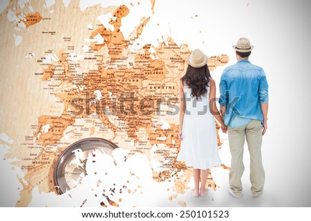 Happy hipster couple holding hands against world map with compass showing southern asia