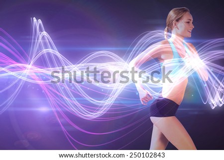 Fit woman jogging against black background with spark