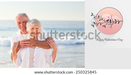 Man hugging his wife on the beach against love birds