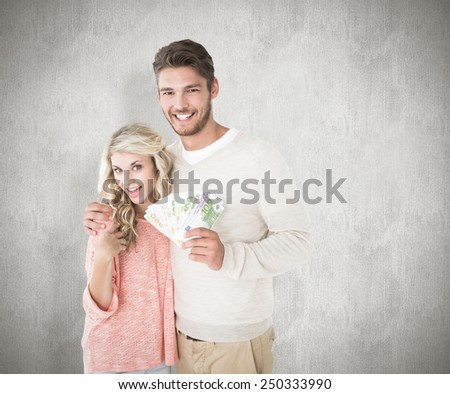 Attractive couple flashing their cash against white background