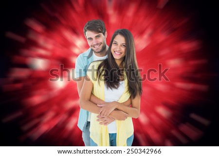 Happy casual couple smiling at camera against valentines heart design