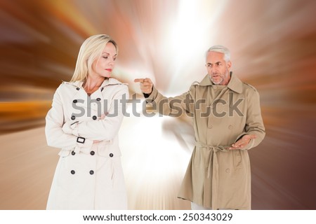 Angry couple fighting in trench coats against blurry new york street