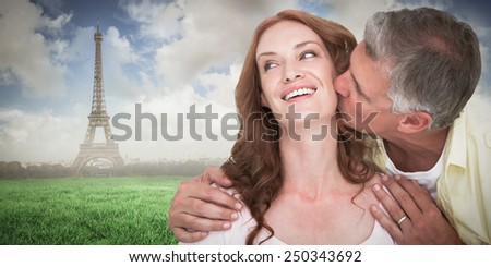 Man giving his partner a kiss against eiffel tower