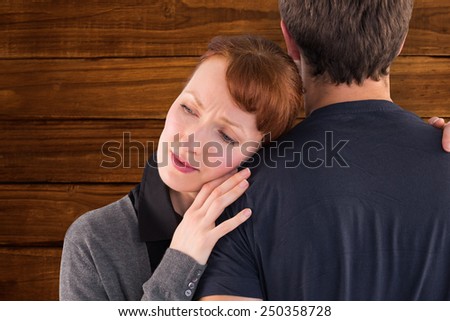 Scared woman holding onto man against overhead of wooden planks