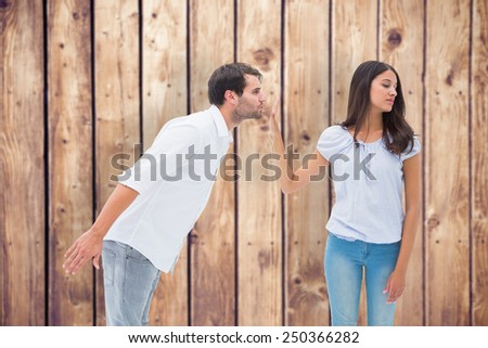 Brunette uninterested in mans advances against wooden planks background