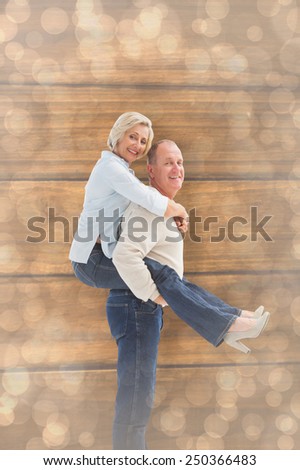 Happy mature couple having fun against light glowing dots design pattern
