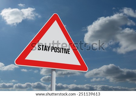 The word stay positive and hazard triangle against sky and clouds