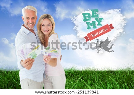Happy couple flashing their cash against cloud heart