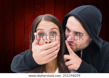 Woman being attacked by scary man against wooden planks