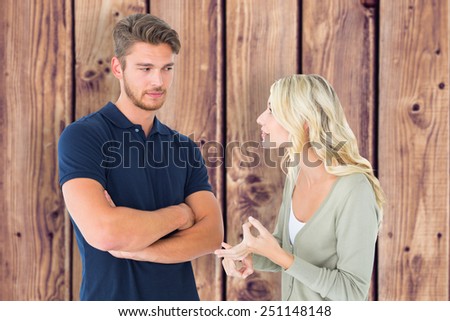 Young couple having an argument against wooden planks background