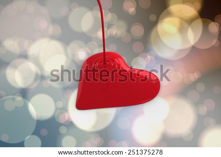 Liquid heart pouring against light glowing dots design pattern