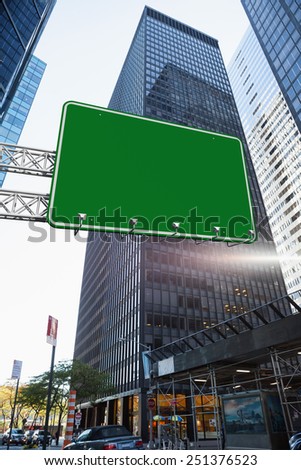 The word a new you and green billboard sign against skyscraper in city
