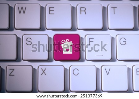 gift with heart against pink key on keyboard