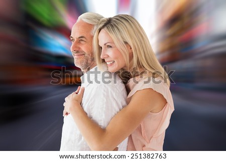 Affectionate couple standing and hugging against blurry new york street