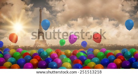 Colourful balloons against paris under cloudy sky