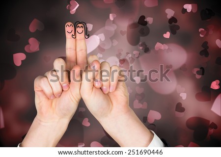 Fingers crossed like a couple against valentines heart design
